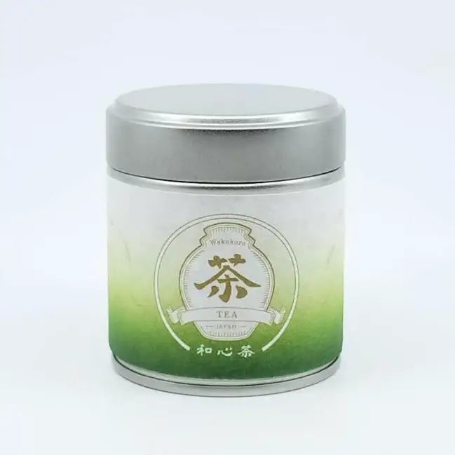 Japanese green tea tin with gradient label and '茶' character, premium loose leaf tea packaging