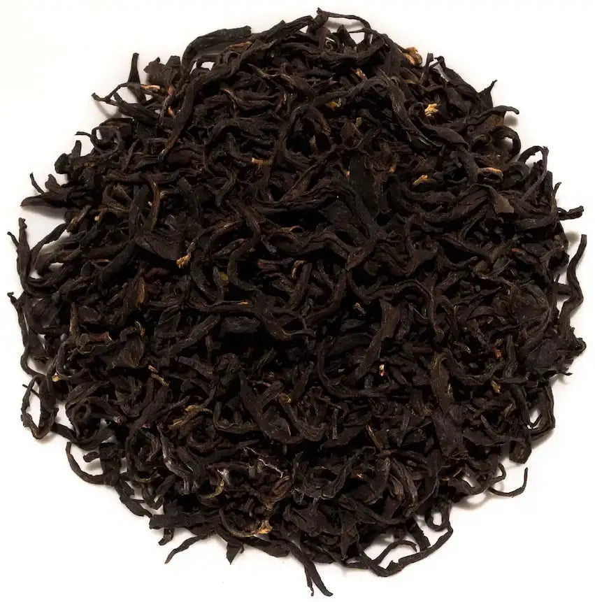 Dark, curly loose leaf black tea on white background, premium Japanese tea
