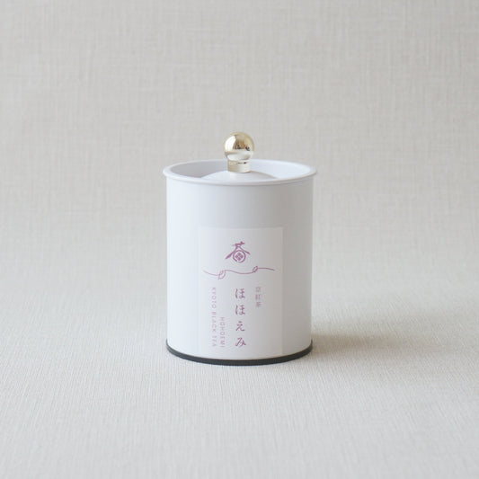 White cylindrical product with black label on a light gray background