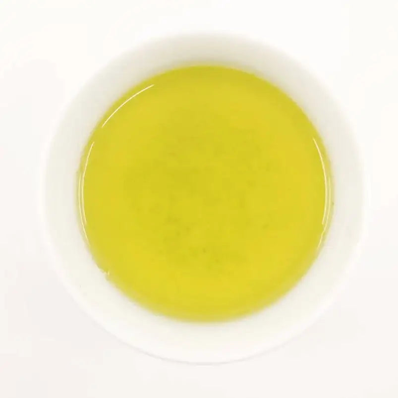Yellow liquid in a white container on a white background