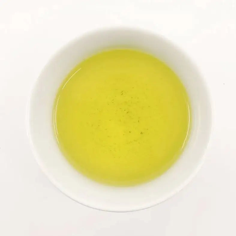 Yellow liquid in a white bowl on a white background