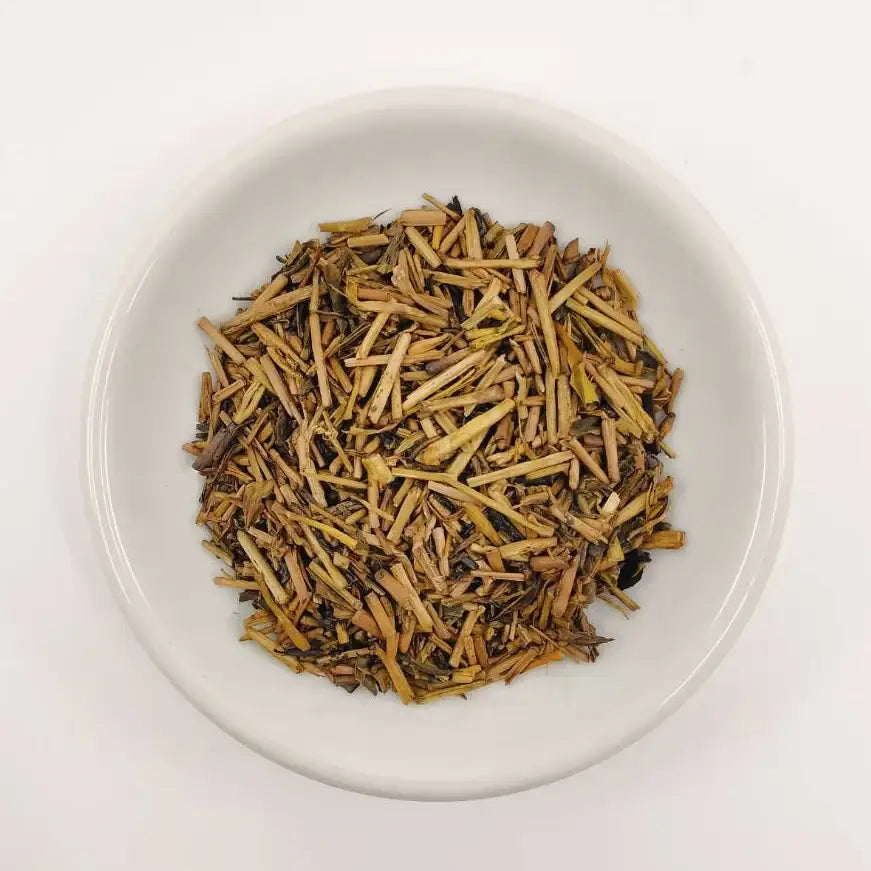 White bowl filled with dried herbs on a white background