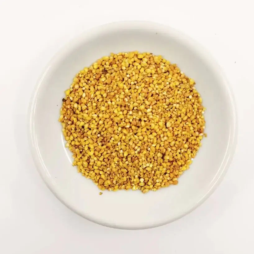 Yellow seeds on a white plate with a white background