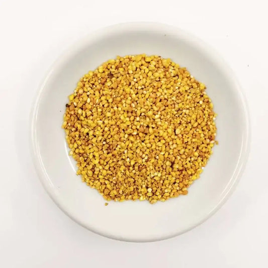 Yellow seeds on a white plate with a white background