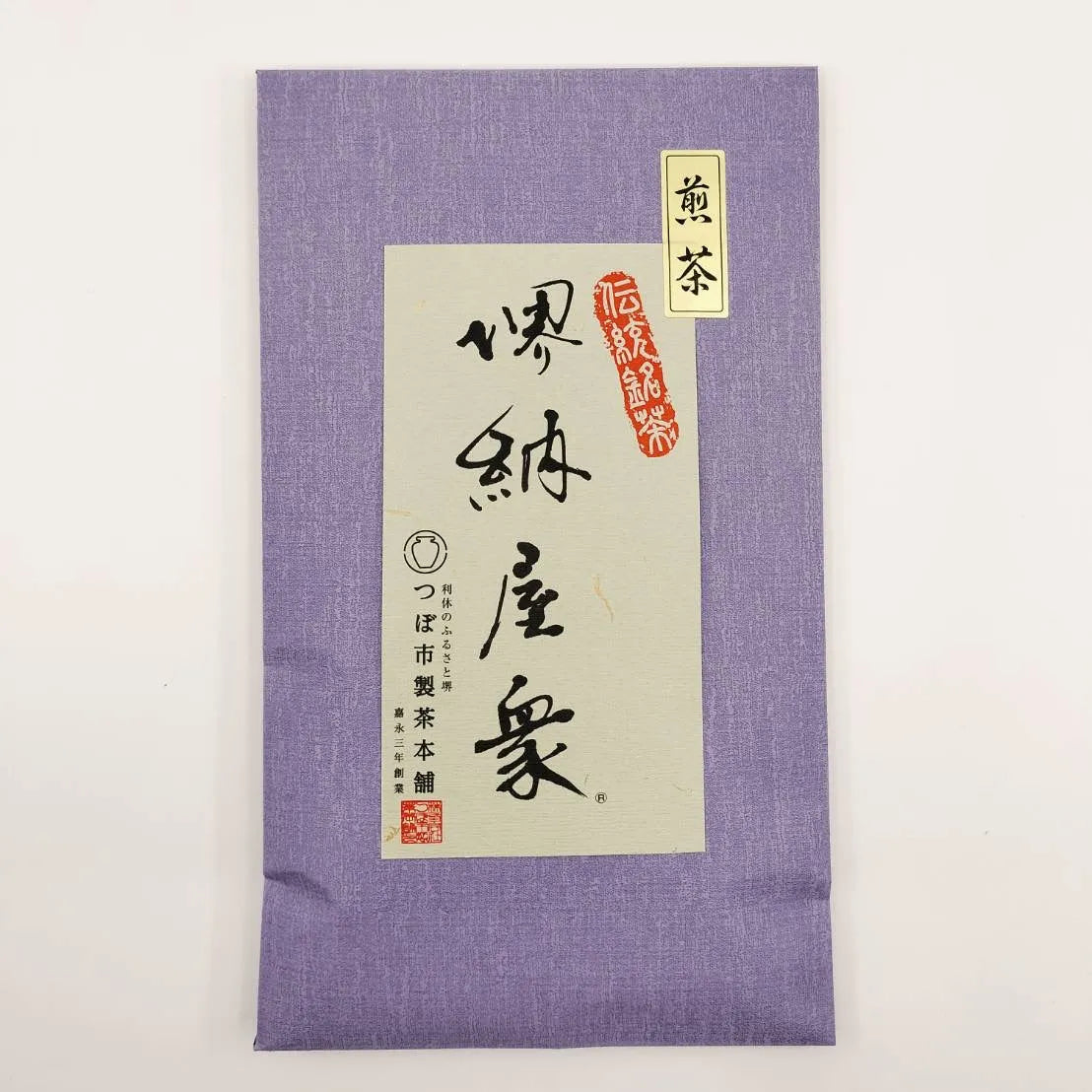 Purple fabric pouch with white label featuring black text and red accents on a light gray background