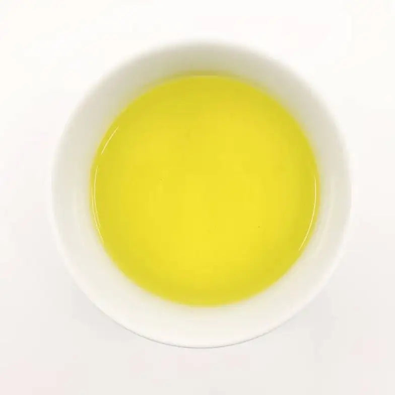 Green tea in a white bowl on a white background