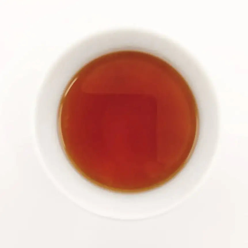Tea bag in a white cup with a white background