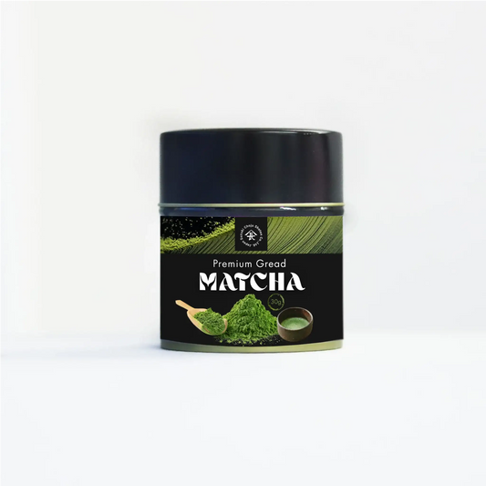 Premium matcha green tea powder tin with spoon and bowl on white background
