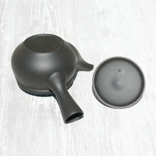 Black ceramic Japanese teapot with lid, handcrafted for premium tea brewing