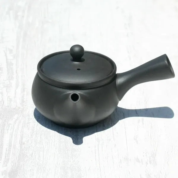 Black ceramic Japanese teapot with lid, perfect for brewing premium tea