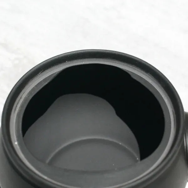 Black ceramic tea infuser with smooth interior, ideal for brewing loose leaf Japanese tea
