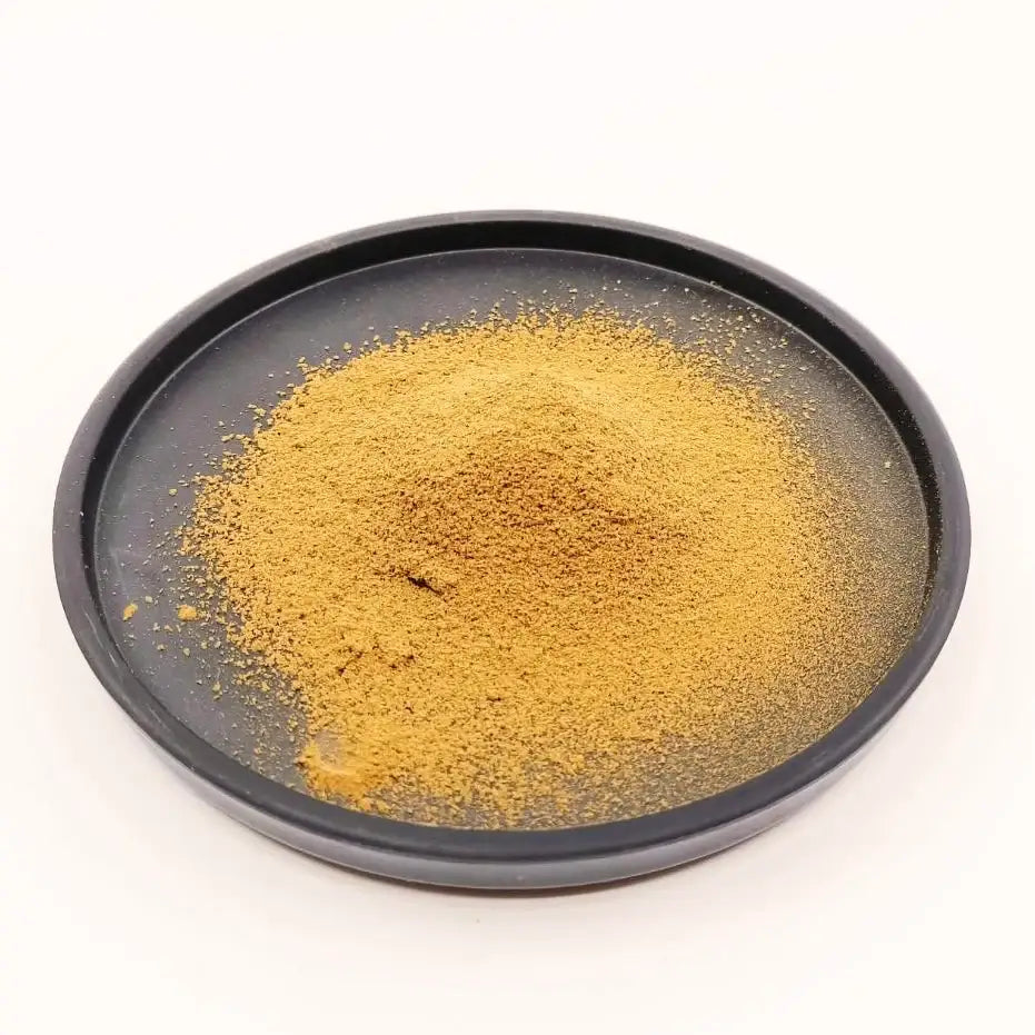 Fine Japanese matcha powder on black ceramic plate, premium tea for authentic brewing