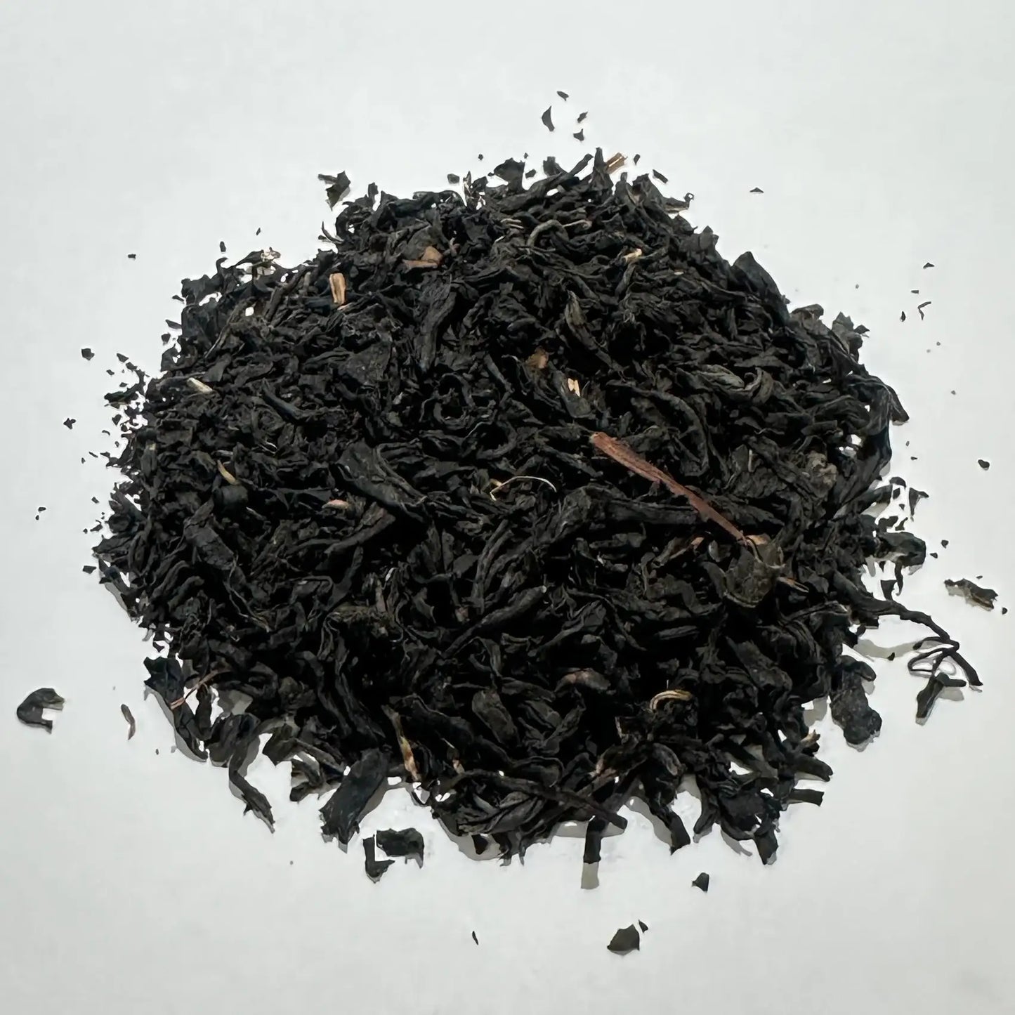 Dark loose leaf Japanese black tea on white background, premium quality tea leaves