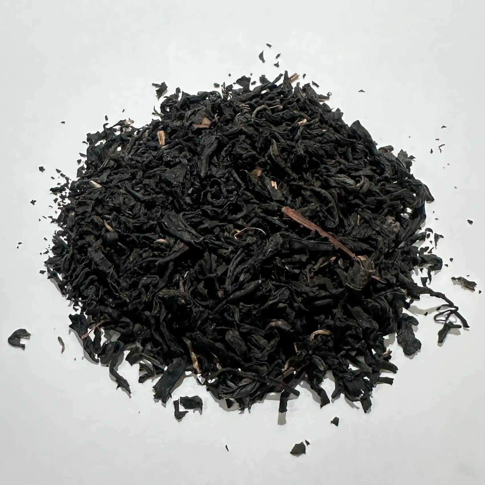 Dark loose leaf Japanese black tea on white background, premium quality tea leaves