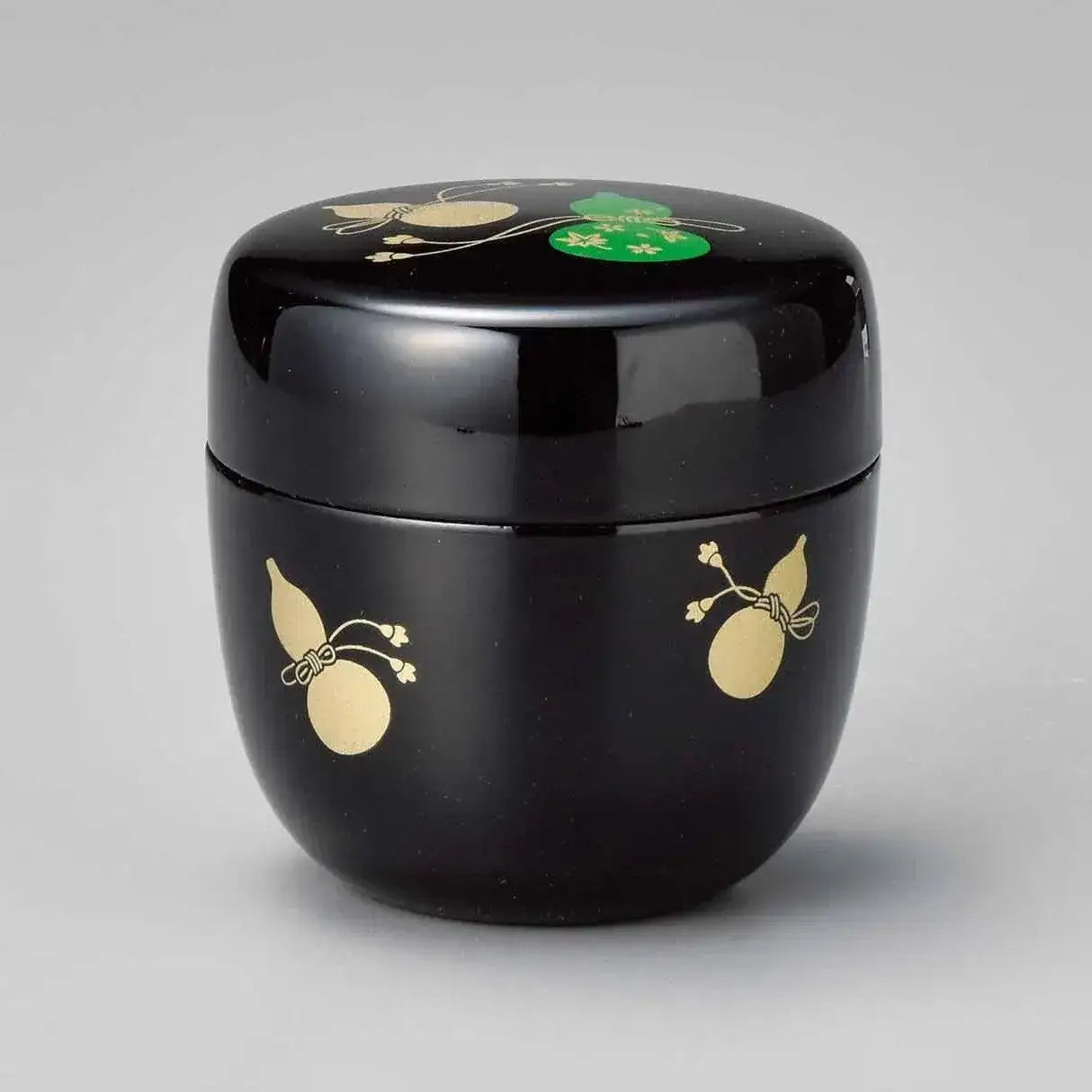 Black lacquer tea caddy with gold and green gourd motifs, handcrafted Japanese teaware